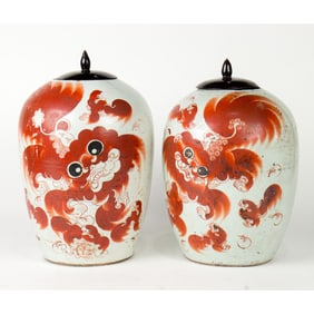 A pair of Chinese iron-red foo dog jars