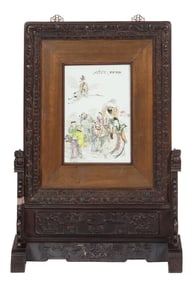 A Chinese famille rose plaque and rosewood table screen