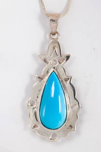 A Turquoise and silver necklace: A Turquoise and silver necklacecentering a pear-shaped turquoise measuring approximately 24.15 x 11.34 x 5.80 mm, suspending from snake link chain; 12.70 grams; pendant length: 2 in