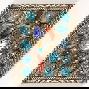 A Native American turquoise, coral, lapis lazuli, mother of pearl, and silver belt buckle: A Native American turquoise, coral, lapis lazuli, mother of pearl, and silver belt buckleOf abstract design, centering a geometric inlay, featuring turquoise, coral, and lapis lazuli pieces; 61.60