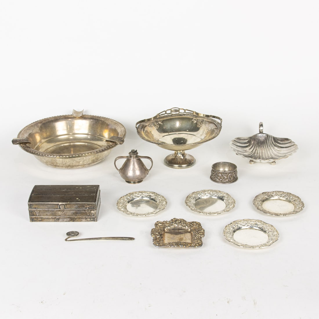 A lot of American sterling table articles: A lot of American sterling table articles, including Gorham box fashioned as a trunk, #4040; Tiffany silver cigar lamp, #16880 9455; (4) S. Kirk & Son butter pats, #17F; Shreve & Co square butter pat;