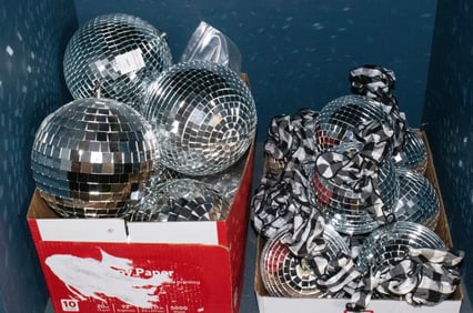 A collection of thirteen mirrored ball ornaments