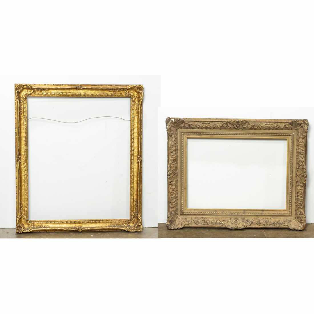 Two picture frames: Two picture frames, the first Neoclassical style with gilt gesso design, 30.5"h x 25.25"w (rabbet); 36"h x 31"w (overall); the second Regence style with burnished gilt finish, 23.5"h x 16.75"w (rabbet