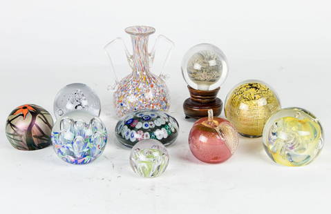 A collection of nine art glass paperweights: A collection of nine art glass paperweights, including one with gilt foil inclusions, signed, and a Chinese reverse painted orb, together with a Murano blown glass vase and a Modern Classics lucite Pi