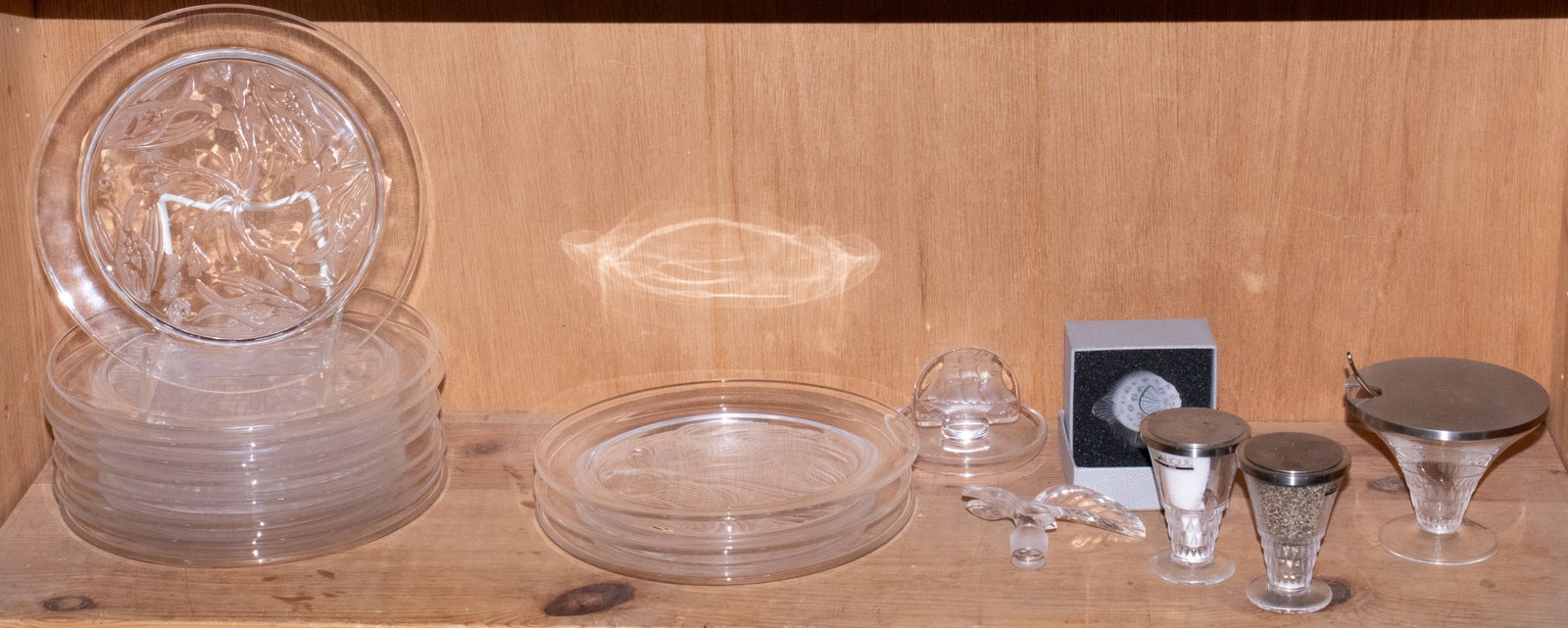 A group of Lalique glass: A group of Lalique glass, including 'Poisson Lune' fish seal or cachet in box; (12) annual collector plates, 8.25"dia; 'Caravelle' pintray; pair of salt and pepper shakers and a matching condiment bow