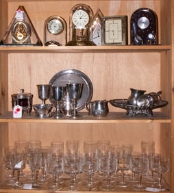 An assembled group of desk clocks, stemware and silver plate