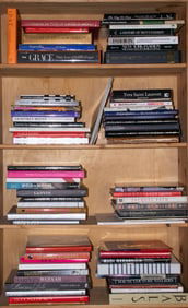 Four shelves of hardcover books on fashion and fashion history