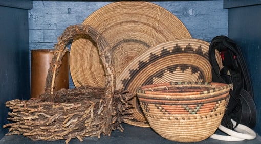 An assembled group of baskets with a copper vessel