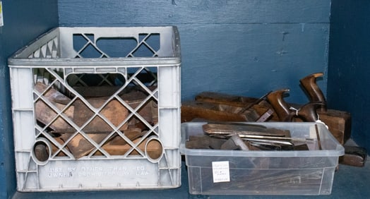 A large group of wooden carpenter planes and blades