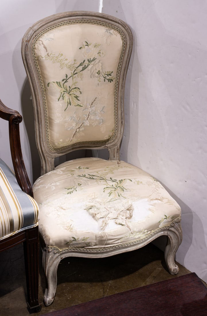 A Louis XV chauffeuse chair: A Louis XV chauffeuse chair, 18th century, with early fabric and polychrome surface, 33"h