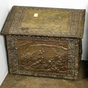 A Continental brass repousse covered wood coal bin