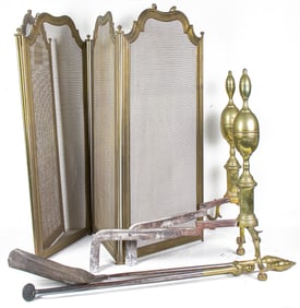 A group of brass fireplace accessories