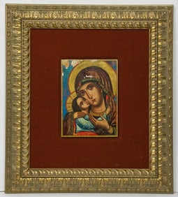 A framed icon on wood panel of Virgin and Child