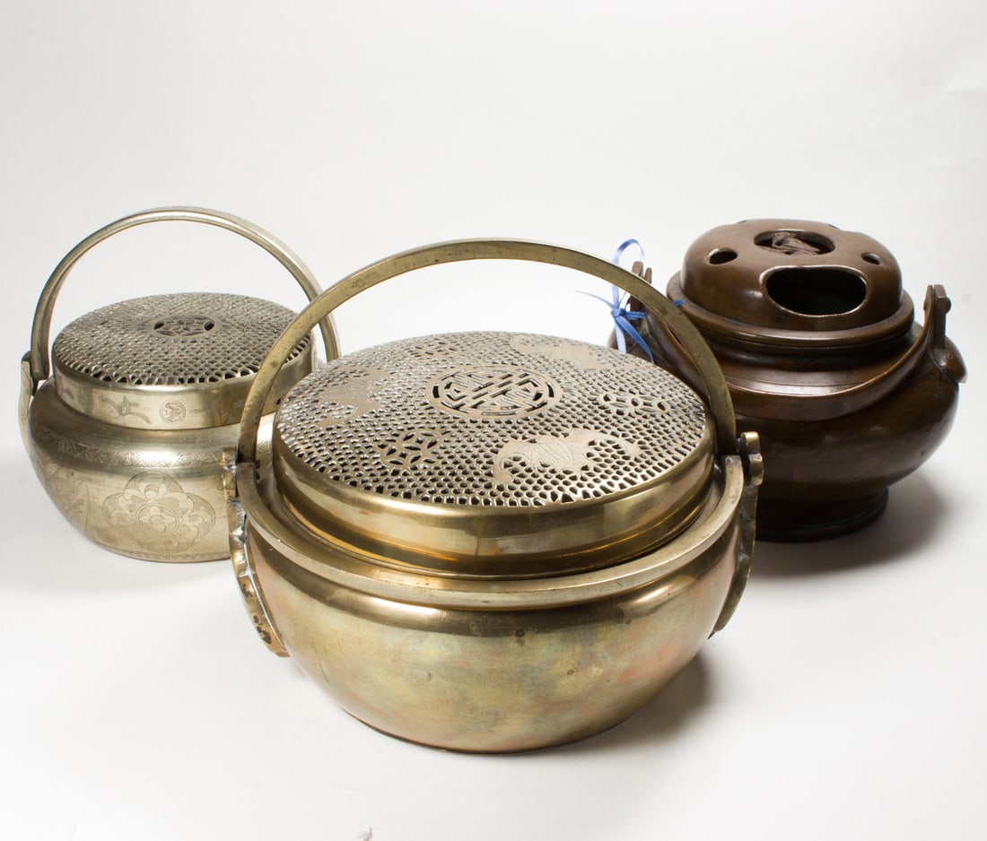 (lot of 3) Chinese metal handwarmers: (lot of 3) Chinese metal handwarmers. Featuring bat, crane, and floral designs, 7.25" across.