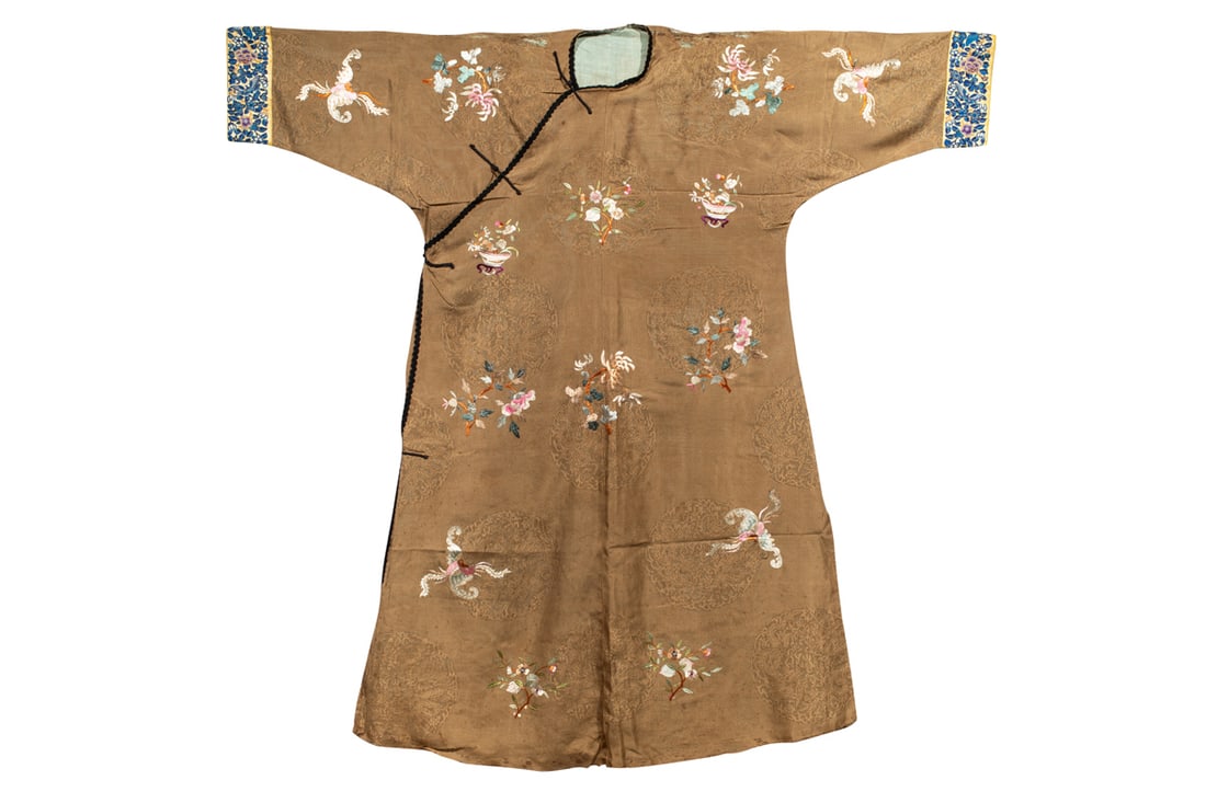 A Chinese yellow ground satin informal lady's robe: A Chinese yellow ground satin informal lady's robe. Featuring scattered scheme of dragon roundels, stitched with various floral motifs and butterflies, sleeves decorated with forbidden stitched floral