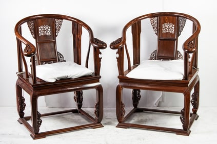 A pair of Chinese hongmu horseshoe-back armchairs