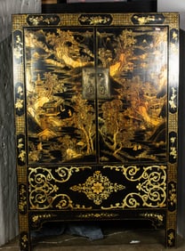 A Chinese gilt lacquered black-ground cabinet