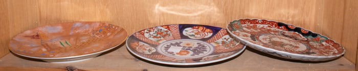 A shelf of Japanese Imari dishes and plates