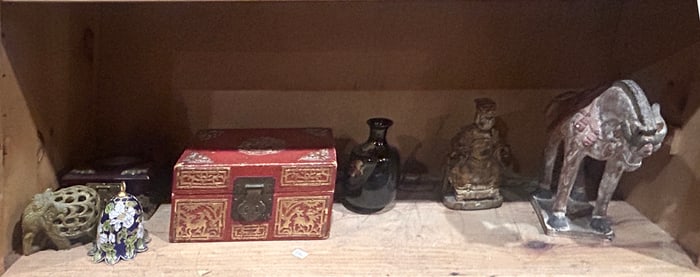 A shelf of Asian decorative items