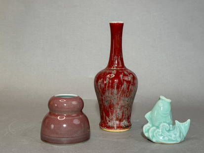 Three Chinese Monochrome Porcelain Vases: (lot of 3) Three Chinese monochrome porcelain vases. Beehive water pot: 3.2"h (8.13 cm); peach bloom vase: 9"h (22.86 cm); celadon fish shaped miniature vase: 3.25"h (8.26 cm) Provenance: From a singl