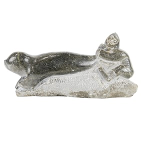 An Inuit stone figure of a seal hunter