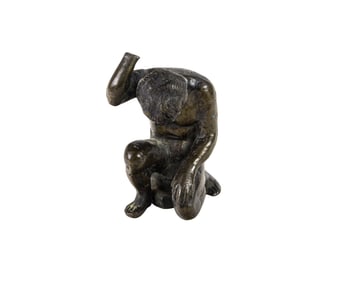 An Italian Renaissance patinated bronze figure of a kneeling youth