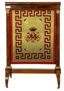 An Empire bronze mounted mahogany needlepoint fire screen: An Empire bronze mounted mahogany needlepoint fire screen, 19th century, decorated on either side with monogram, raised on casters, 40"h x 27"w