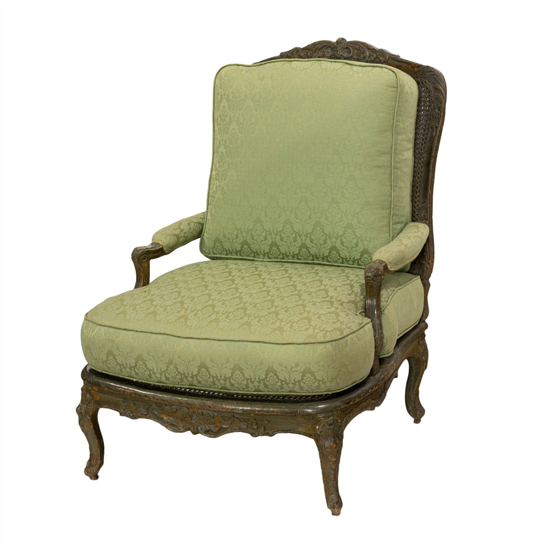 A Louis XV period fauteuil a la reine circa 1750: A Louis XV period fauteuil a la reine circa 1750, the carved crest with floral and shell carved reserves flanking the cane seat and back fronted with the later cushions and rising on carved cabriole l