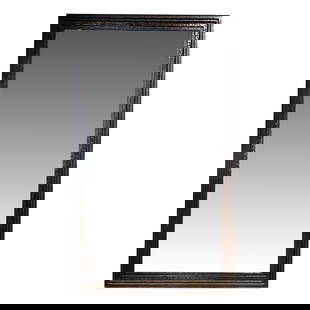 A contemporary Brutalist mirror: A contemporary Brutalist mirror, with a hand hammered and textured metal frame surrounding the bevel mirror, 57.5"h x 34"w Provenance: Purchased Paris, France, circa 2000