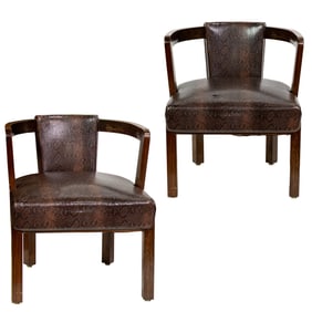 A pair of James Mont stained walnut and faux snakeskin-upholstered oxbow armchairs