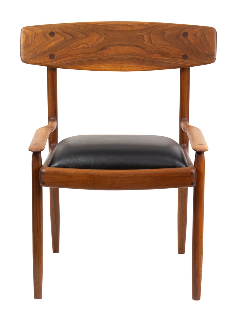A John Nyquist (American,1936-2018) prototype low arm chair 1959: A John Nyquist (American,1936-2018) prototype low arm chair 1959, walnut and black leather, inscribed JN on right side of chair, 33.5"h x 26.75"w x 23"d Provenance: Bonhams Los Angeles 20th Century De