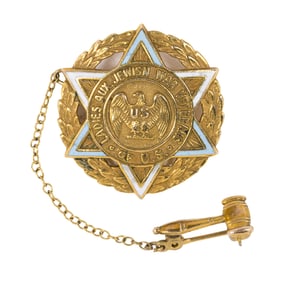 A gold and enamel brooch