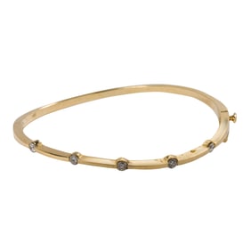 A diamond and 14k gold bangle bracelet