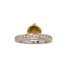 A colored diamond, diamond and 18k white gold ring