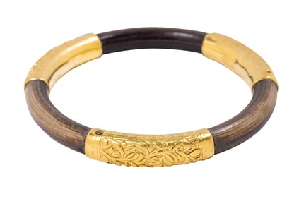 A wood and high karat gold bangle bracelet