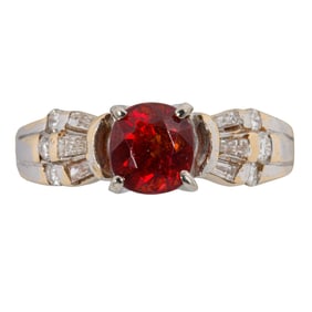 A diamond, orange sapphire, and 14k gold ring