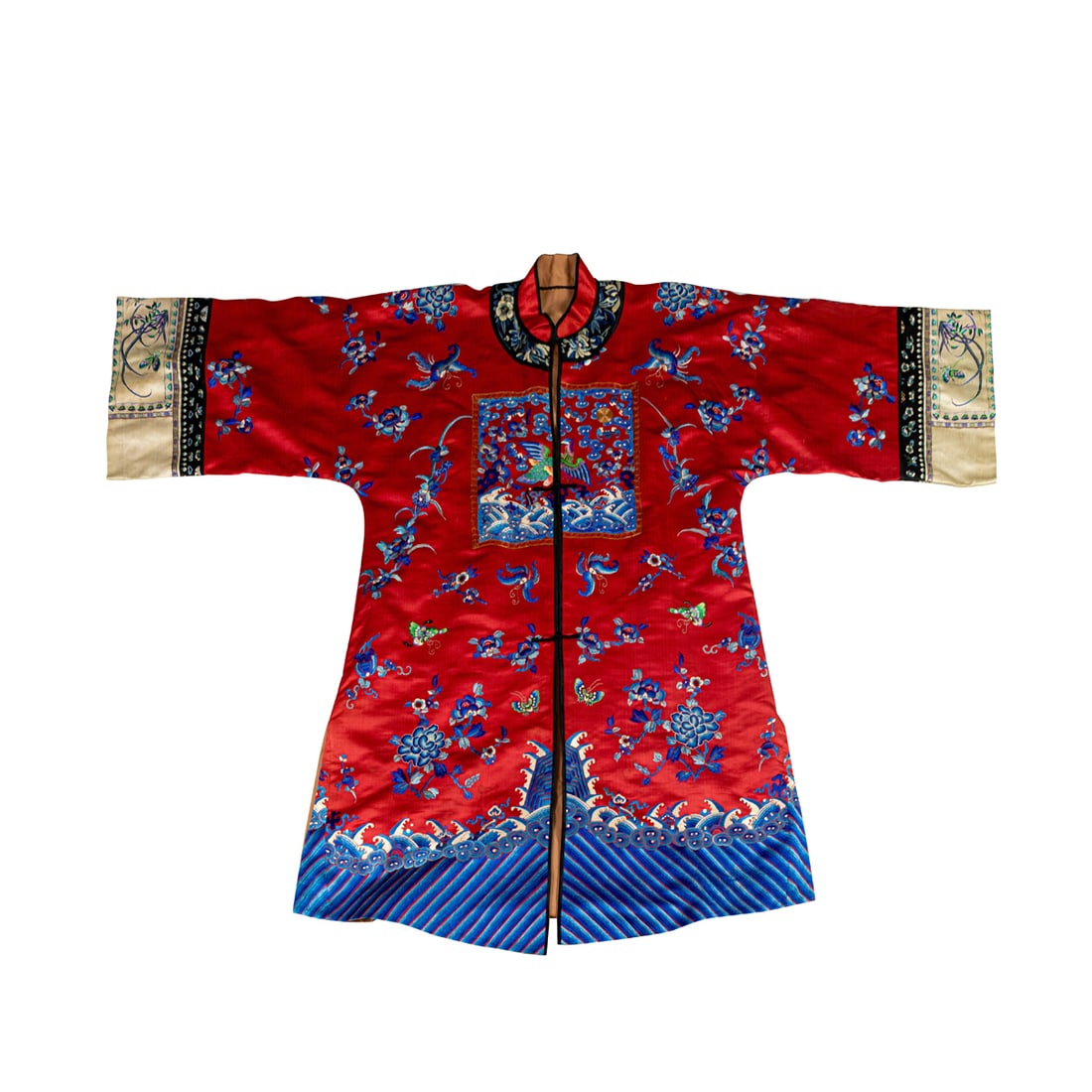 A Chinese embroidered lady's robe with rank badges: A Chinese embroidered lady's robe with rank badges. Featuring badges in the front and back surrounded by butterflies and peonies above the lishui border and cresting waves, late Qing period, 39"h x 58