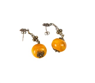 A pair of Chinese butterscotch amber and silver filigree ear clips