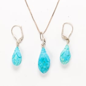 A turquoise and silver earring and necklace set
