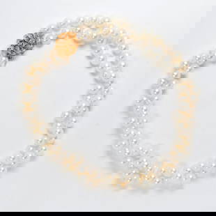 A cultured pearl and 14k gold necklace: A cultured pearl and 14k gold necklacedesigned as a double-strand of 50 cultured pearls, joined by botanical motive clasp; 82.10 grams; length: 36 in