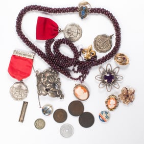 A group of pins, medals, coins and jewelry