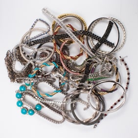A group of metal and hardstone bracelets