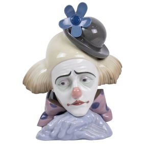 A Lladro porcelain figure of a clown wearing a flower decorated bowler