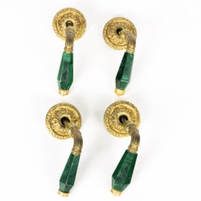 A set of four Louis XVI style gilt bronze and faux malachite door handles