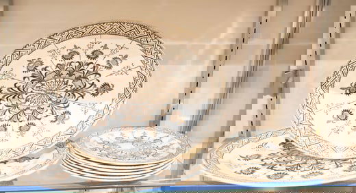 An English Aesthetic Movement brown transfer printed plates and platters in the 'Aster' pattern