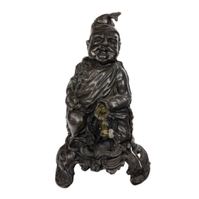A cast iron comedic figure of a seated man