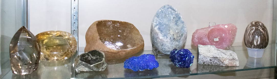 A group of specimen stones: A group of specimen stones, including (2) azurite crystals; tourmalated quartz display piece; large rough-cut quartz stone; rose quartz tray; octahedral pyrite; celestite cluster geode; petrified wood