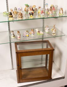 Twenty-three Beswick and Royal Albert Beatrix Potter ceramic figures with twelve antique bottles