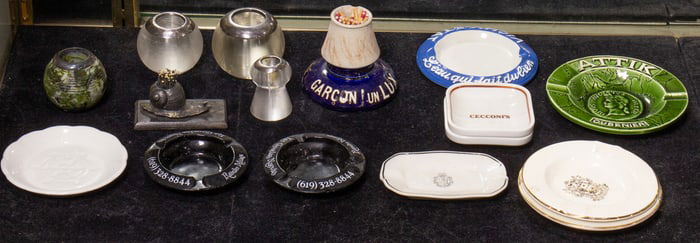 A group of matchstikers and ashtrays