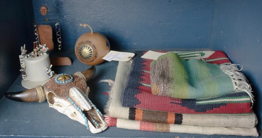 An assembled group of (3) Mexican blankets; (3) Native American sculptures in ceramic; (1) carved